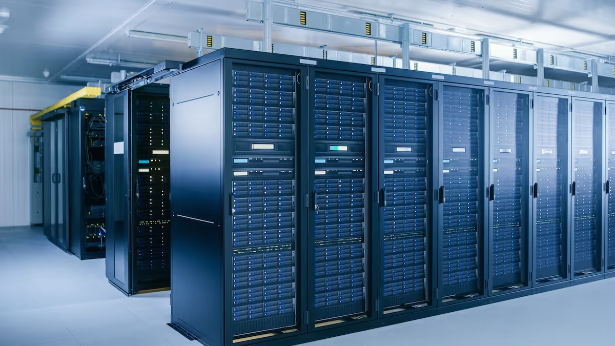 Row of black server racks in a brightly lit data center.